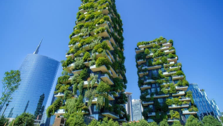 two skyscrapers covered in plants and trees